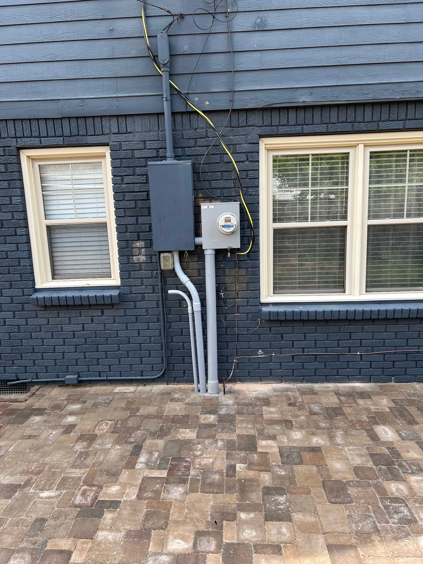 Completed exterior service entrance on a Tulsa home — meter, mast, and conduit installed by M Electric as part of a service upgrade